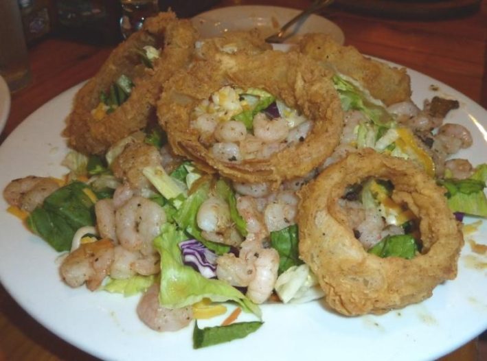 Fried Onion Rings on Shrimp Salas Giant Fried Onion Rings on salad at Love & War Restaurant