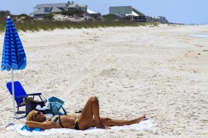 Woman laying on the beach Woman with swimsuit laying on the beach