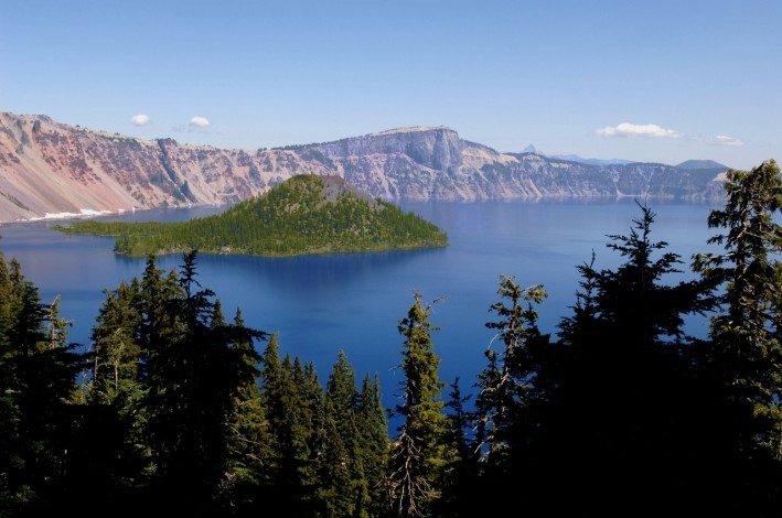 Crater Lake Scenic. View of Crater Lake from behind trees on a sunny day