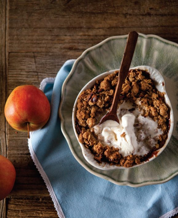 apple crisp with ice cream from above with whole apple next to plate Gluten-free Apple Crisp Recipe