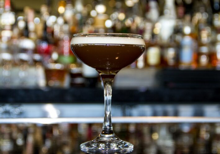 Dark cocktail in coup glass for St. Patrick's Day.
