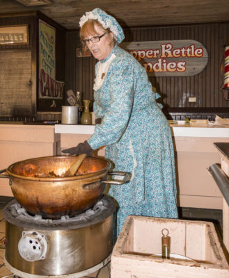 A master candy maker demonstrates making peanut brittle candy at Silver Dollar City.