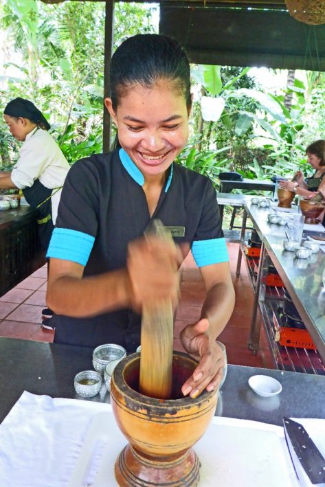 Soyheap demonstrating her mortar technique in a cooking class in Cambodia.
