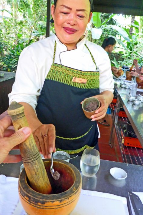 Vone added fish paste to the Fish Amok in a cooking class in Cambodia.
