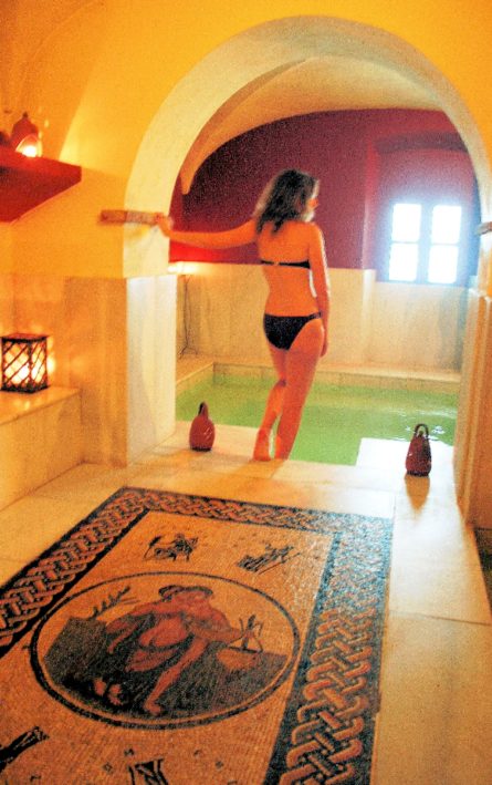 A spa-goer moves from one pool to another at a Spanish Roman Spa.