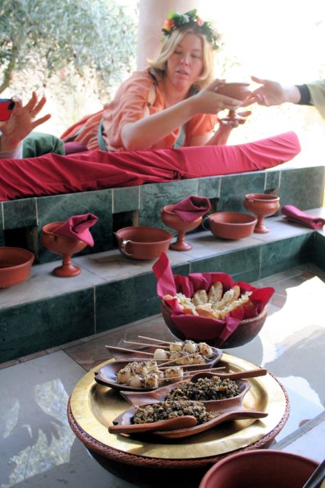 Roman-style dishes float in a pool at a Roman Spa in Spain.