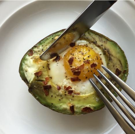 Avocado with baked egg in the center by Vital Farms.