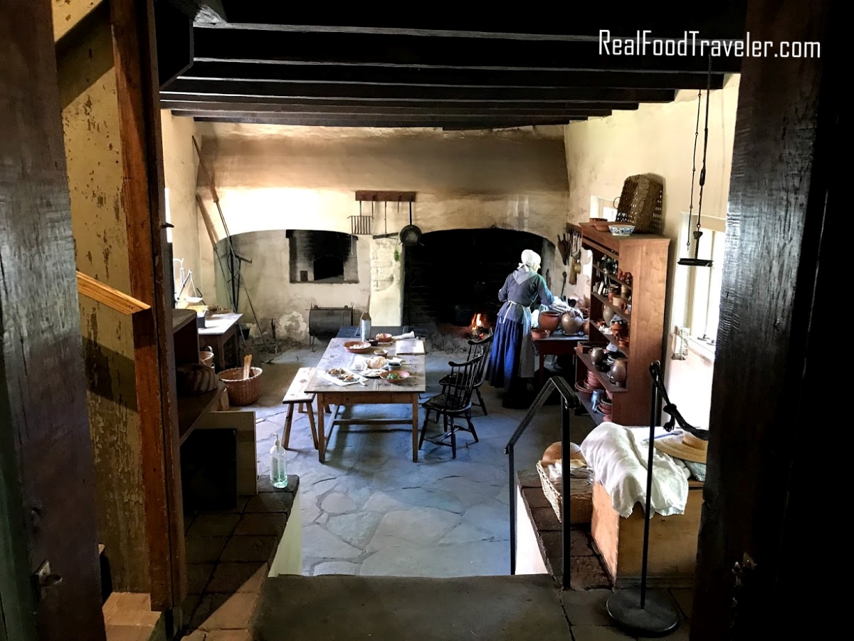 A costumed interpreter prepares food of the day at the back of an Inn in Winston-Salem.