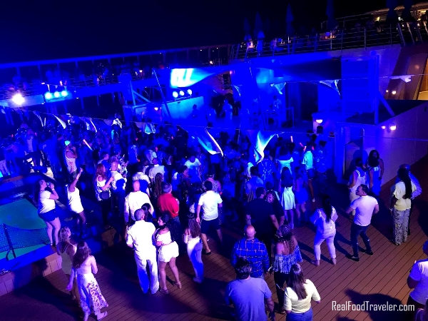 People dancing during a party on the Norwegian Sky ship.