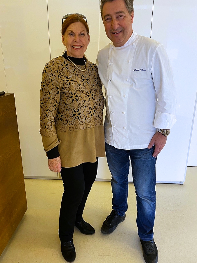 Writer Irvina Lew, left, stands with Chef Joan Roca as he wears his white chef's uniform at El Celler de Can Roca.