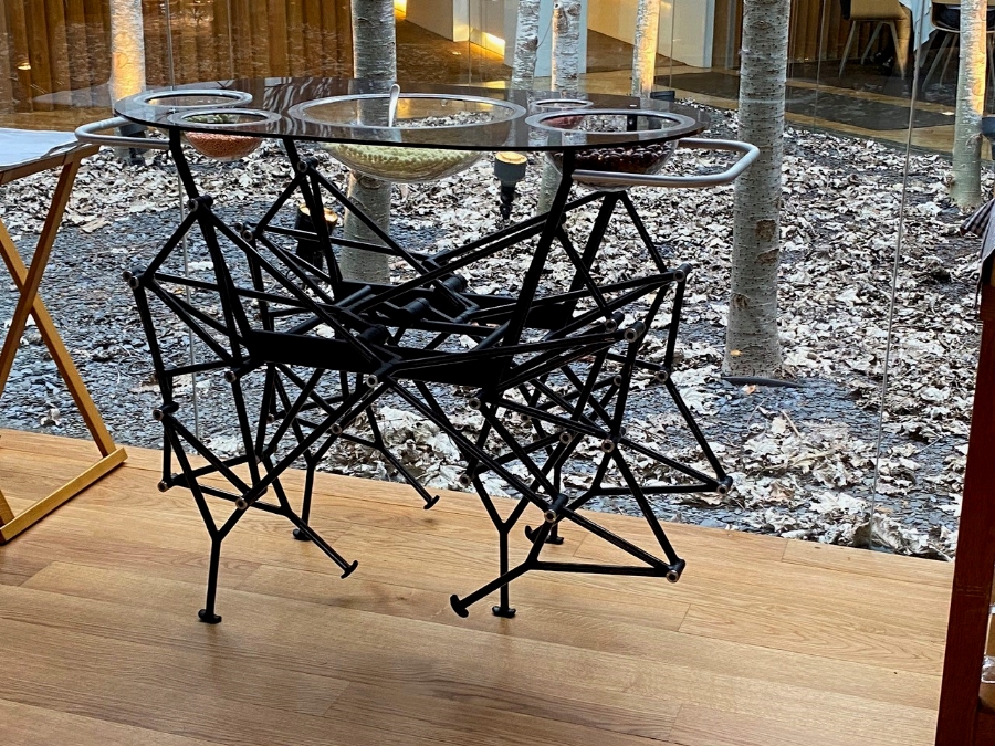 Dessert is served on a tray with spidery metal legs.