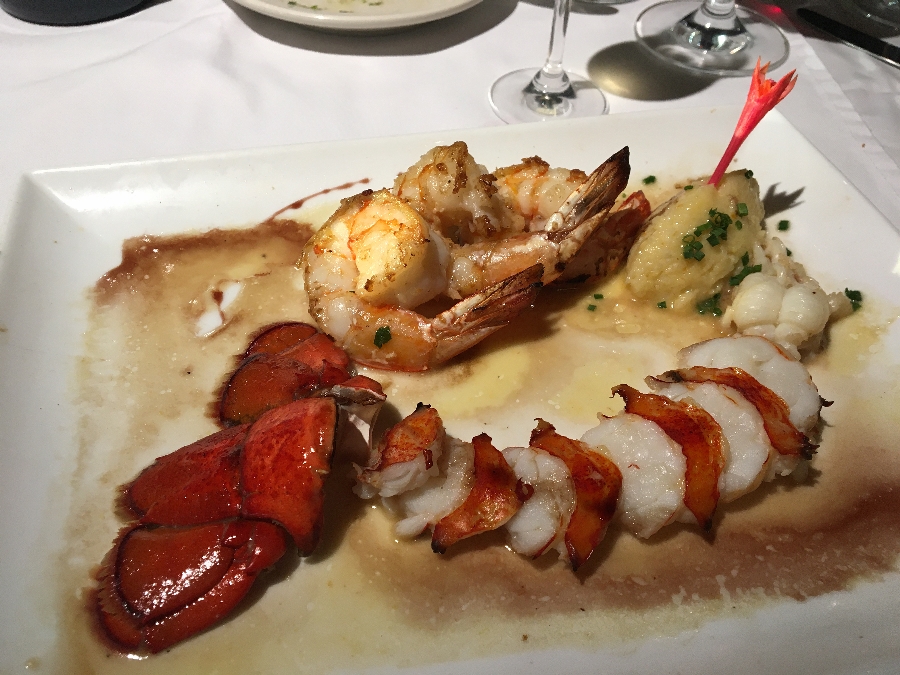 Beach Bistro's butter poached lobster tail is served on citrus grits with shrimp.