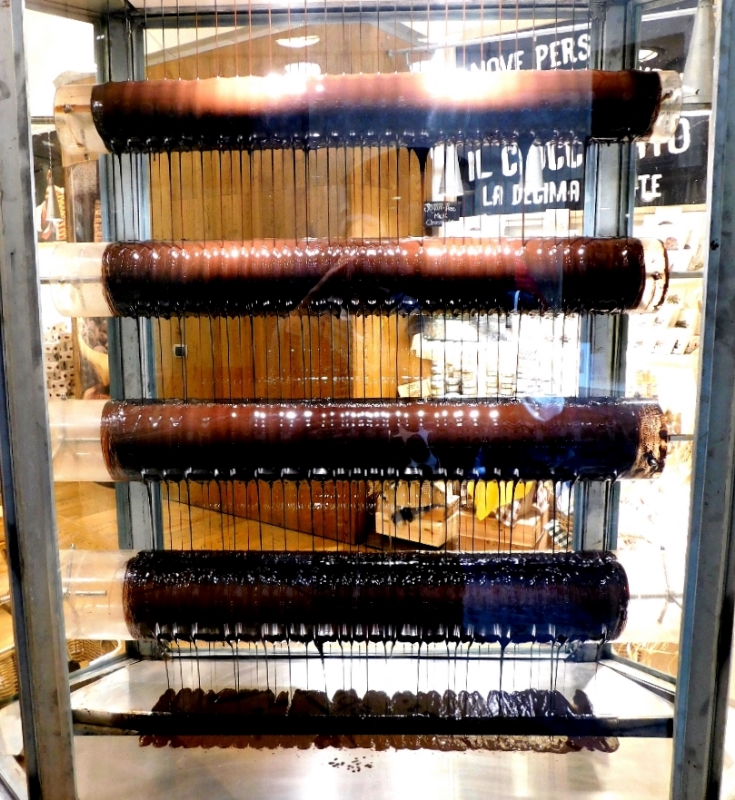 Rows of spindles of chocolate dripping like a waterfall in Italy.