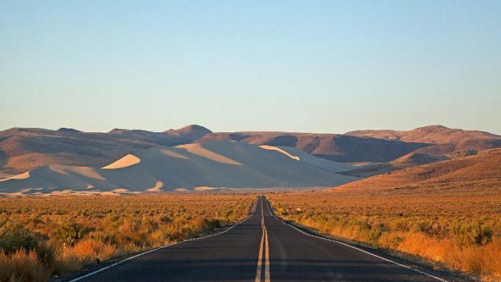 A view of the Loneliest Road with mountains in the distance.