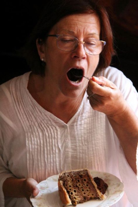 A woman eats "Stone Cake," traditional Croatian cuisine.