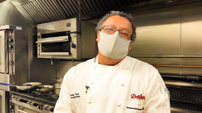 Dollywood Executive Chef Rudy Torres in his kitchen, wearing a mask.