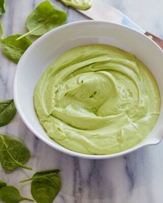 A bowl of green frosting for the Spinach Smash Cake