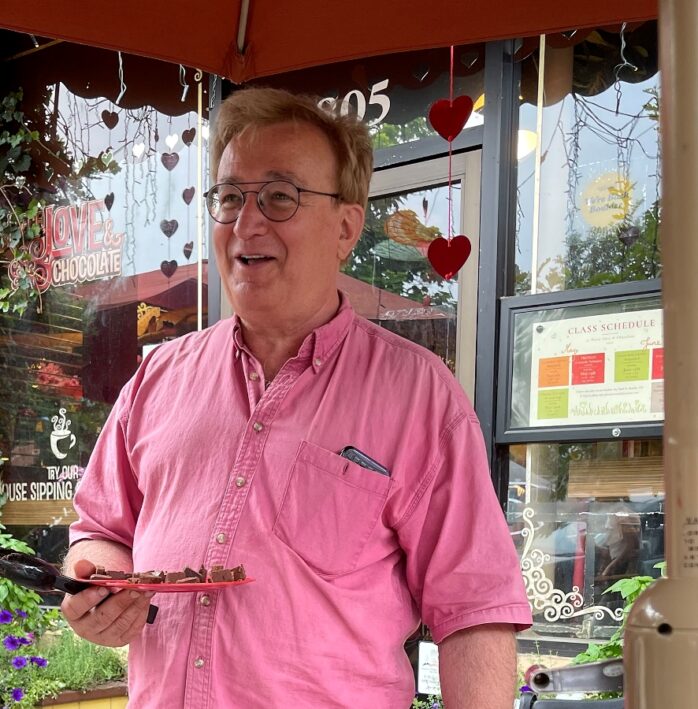 The owner of Piece Love and Chocolate handing out samples.