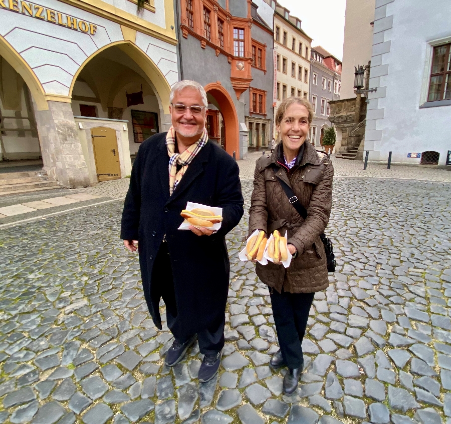 People holding Bratwurst in Dresden, Germany.