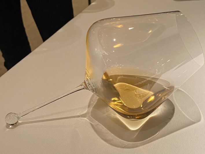 L'Ecrine glass of wine laying on a table