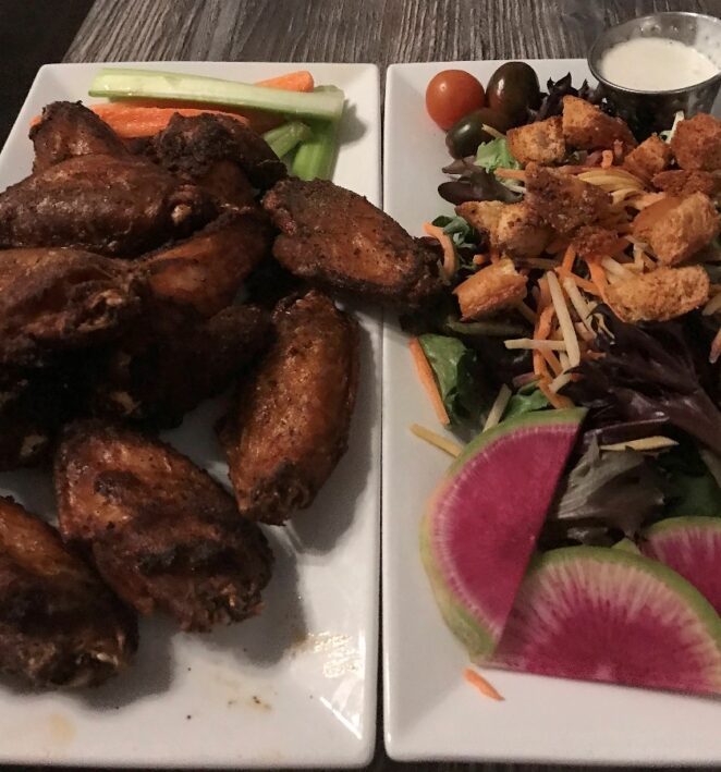 Chicken wings and salad at Eclectic Bar and Grill.