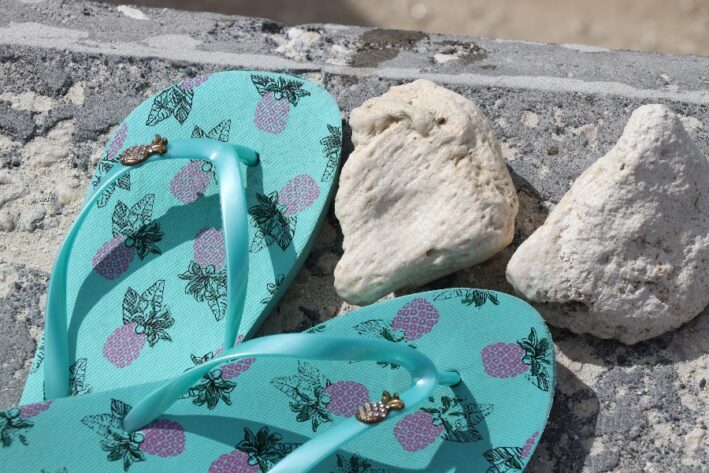 blue flip flops on the beach.