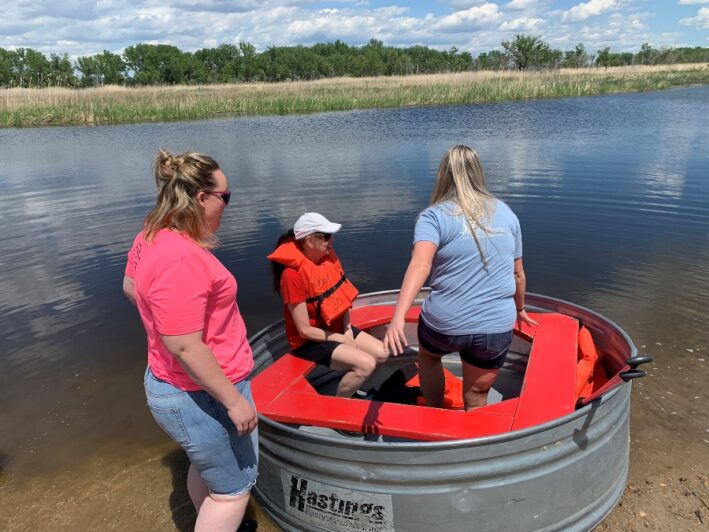 Three people tanking in the river.