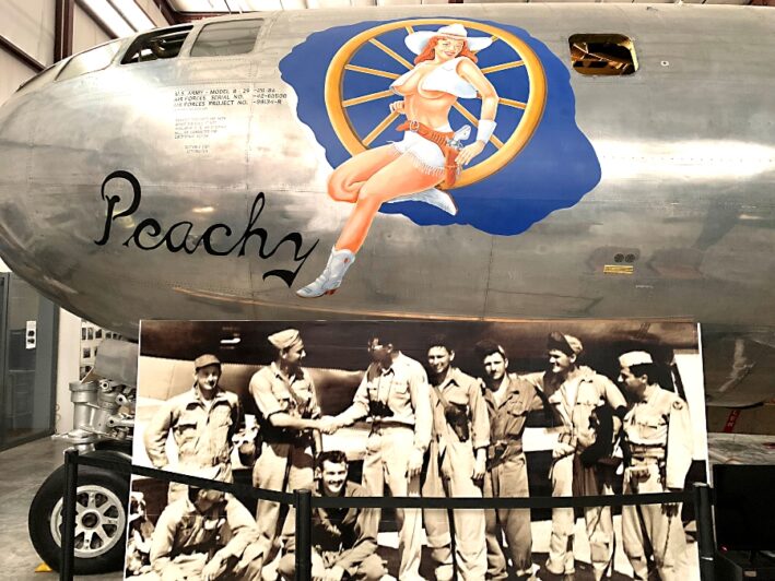 A plane with a woman painted on the side at the Weisbrod Aircraft Museum.