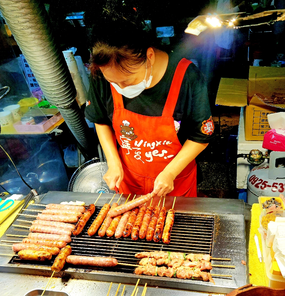 Woman preparing Mountain Pig Sausage in Taipei, one of the Night Markets.