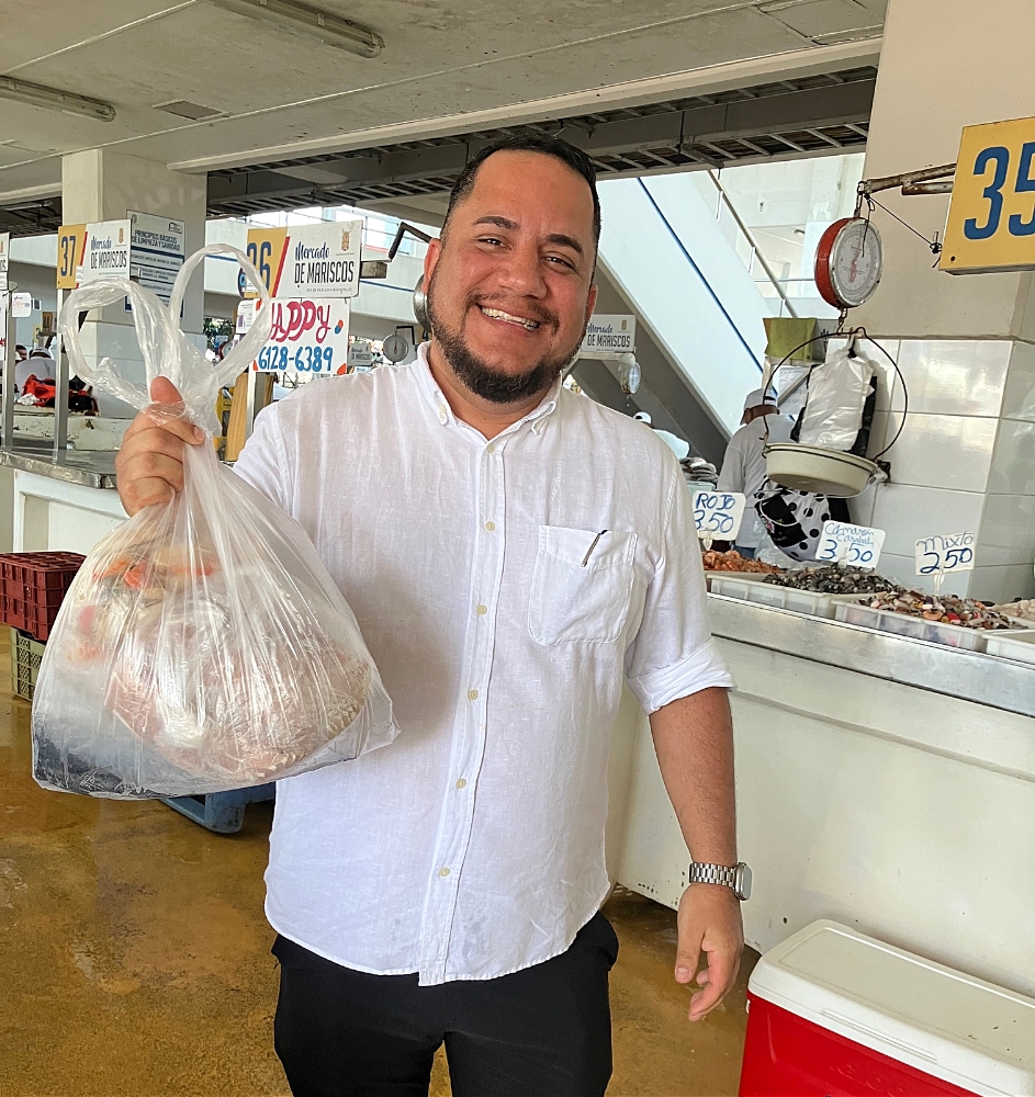 Chef Chavez with a bag of fresh seafood from the market which will be used to make Ceviche.