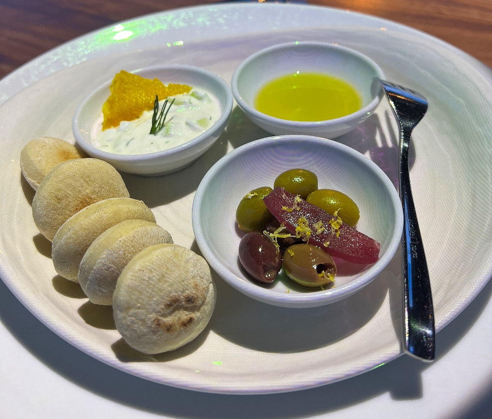 Tiny pita bread, tzatziki, olives and olive oil in the 360 dining experience.