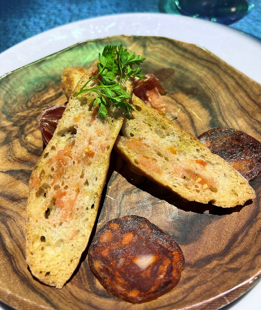 Tomato-rubbed toast with cured meats during the 360 dining experience.