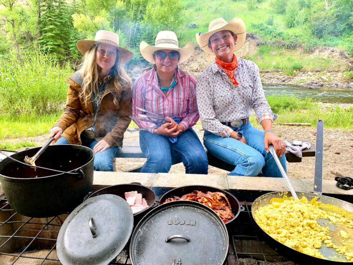 Staff of Bar Lazy J Ranch preparing breakfast alongside the river.