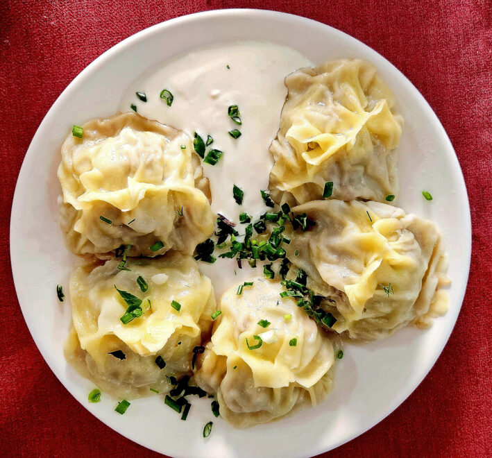 Manti dumplings with yogurt and chive dressing in Central Asia.