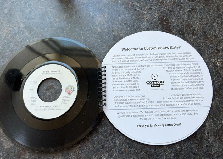 The welcome and information book from the Cotton Court Hotel in the form of a record.