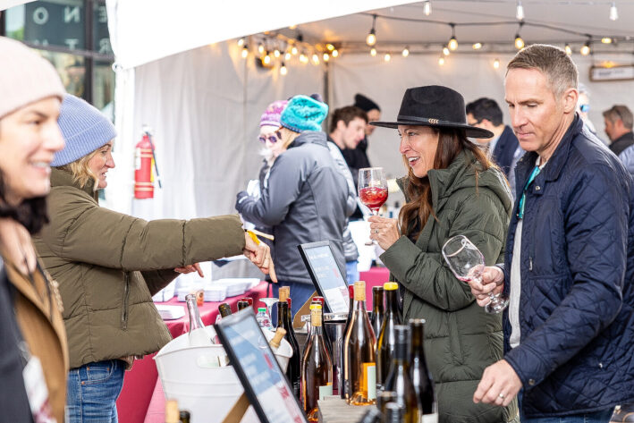 Couple tasting wine at the Grand Tasting at Park City Wine Festival