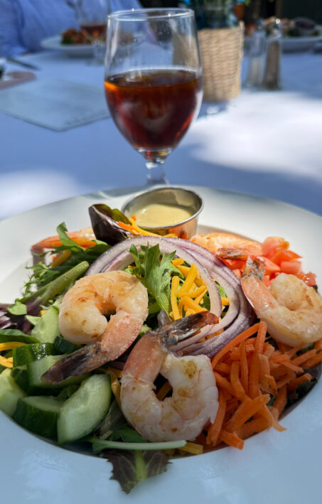 Salad with shrimp and ice tea served at Grove House.