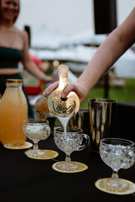 Person pouring cocktails at the Shake + Brake Showdown.
